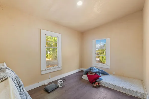 a bedroom with a bed window and dresser