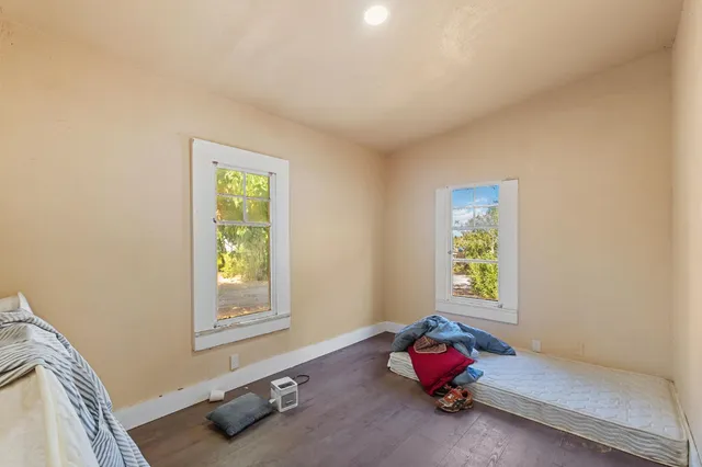 a bedroom with a bed window and dresser