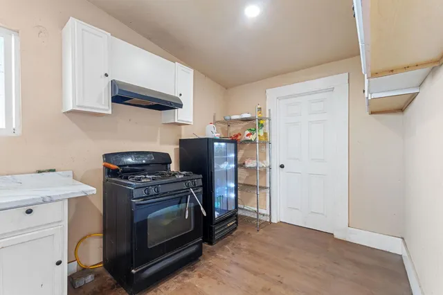 a living room with furniture a flat screen tv and a couch