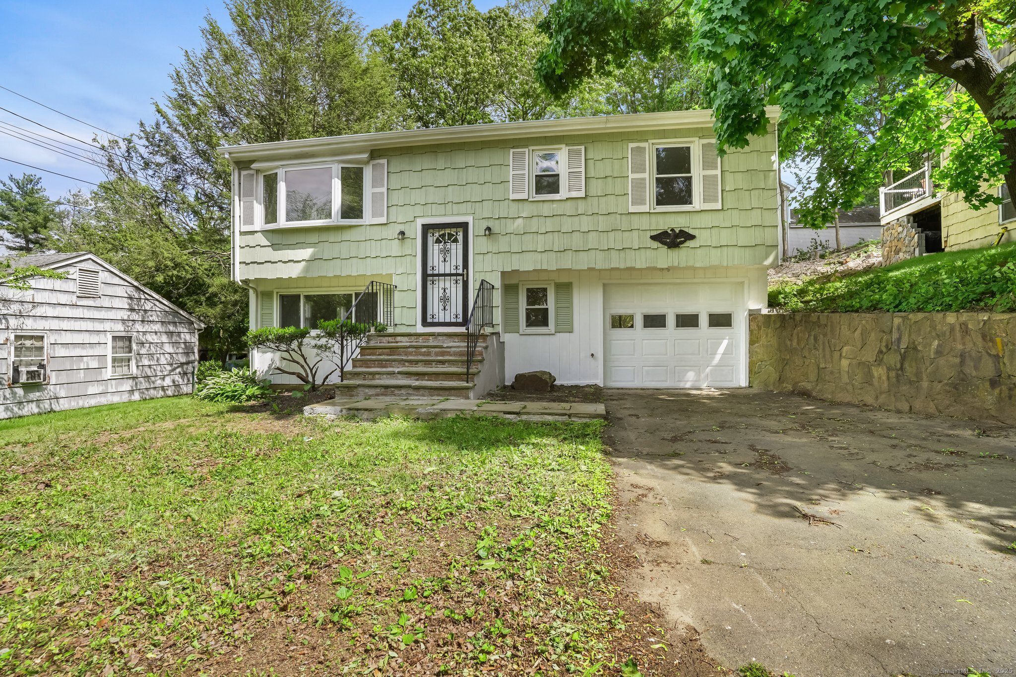 a view of a yard in front of a house with large tree