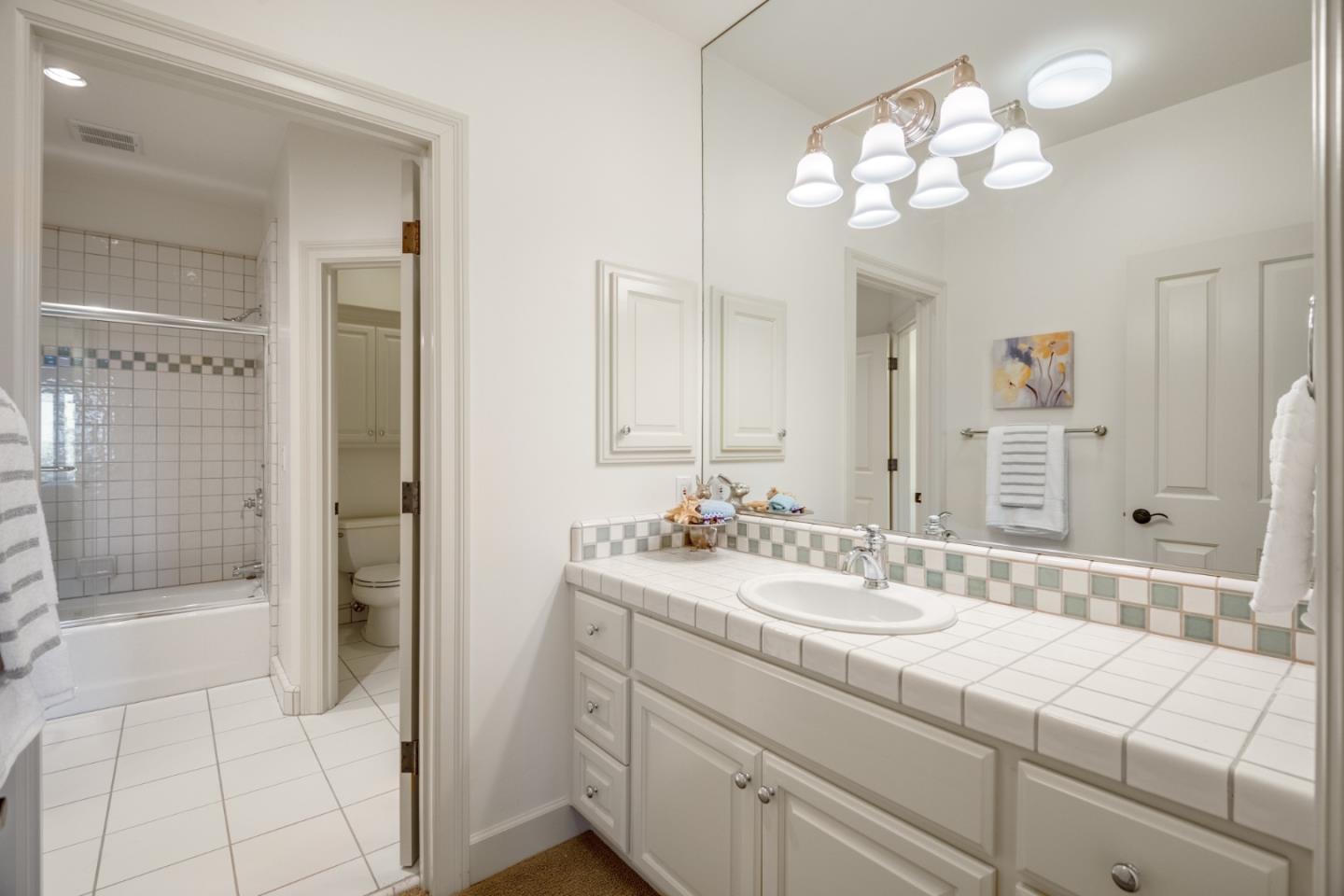 1795 Foster Road Los Gatos, CA 95030 - Photo 53 of 56 a bathroom with a sink vanity granite shower and a mirror