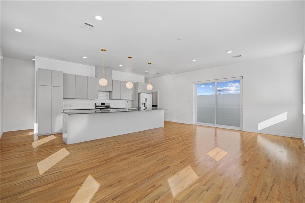 1715 Bennett Avenue, Unit 104 Dallas, TX 75206 - Photo 13 of 35 a view of kitchen with kitchen island and stainless steel appliances