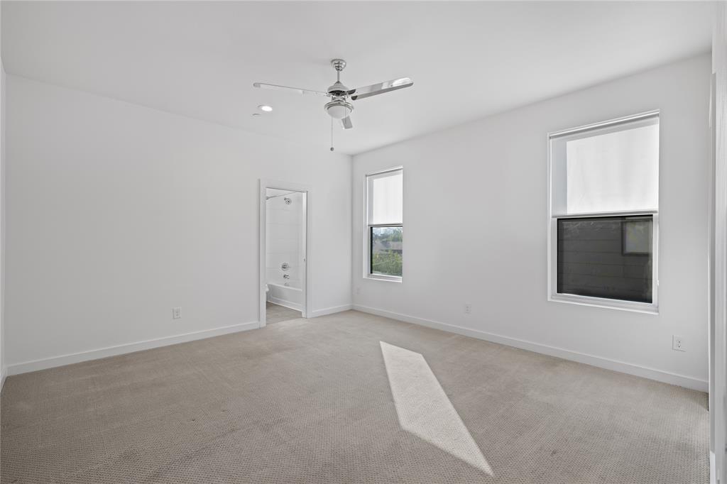 1715 Bennett Avenue, Unit 104 Dallas, TX 75206 - Photo 26 of 35 a view of an empty room with a window and a kitchen
