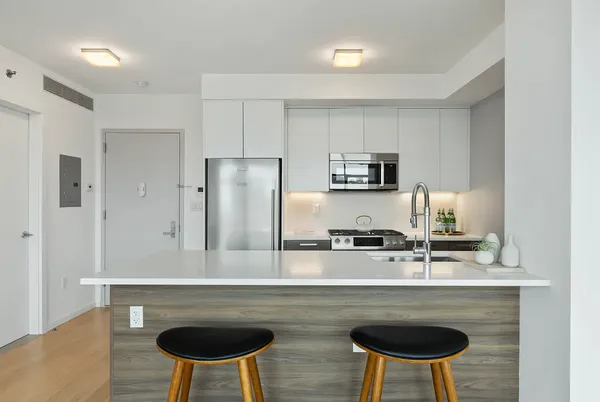 a kitchen with a refrigerator a stove a sink and a microwave