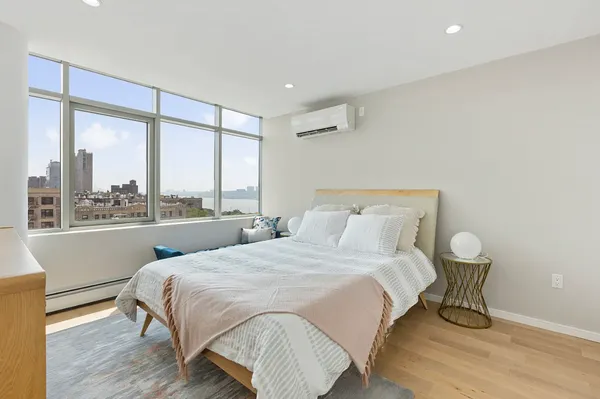 a bedroom with a large bed and a large window