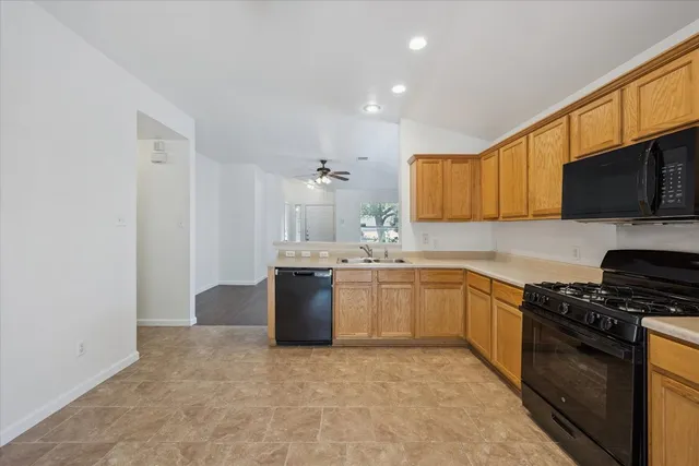 a kitchen with granite countertop a sink and a stove top oven