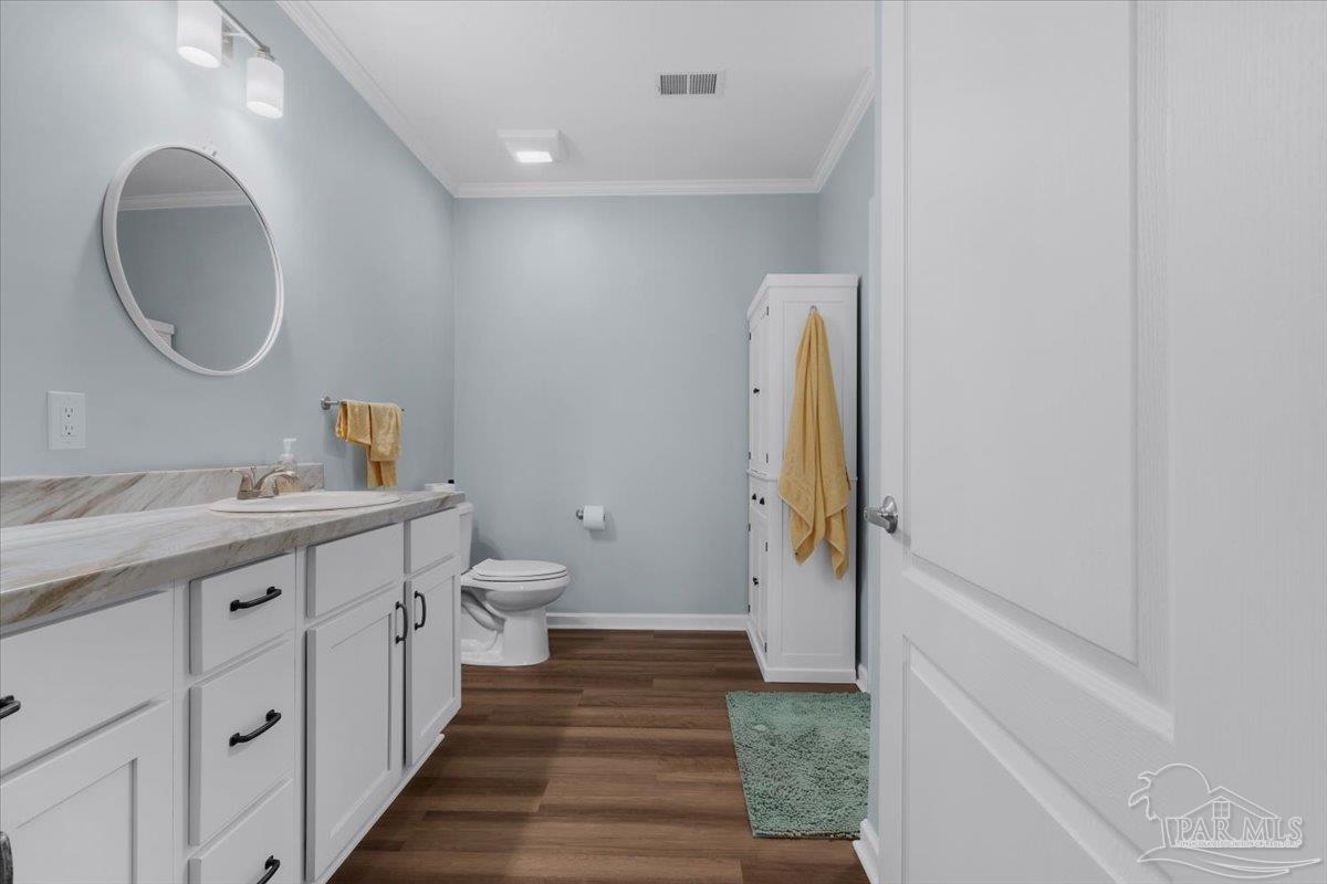 4955 Blue Ribbon Drive Milton, FL 32583 - Photo 17 of 32 a bathroom with a sink and a mirror