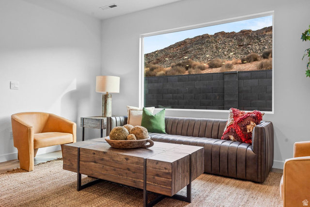 1624 South Staircase Way, Unit 4183 Washington, UT 84780 - Photo 6 of 47 Spacious living area featuring a large horizontal picture window, wood-finish flooring, and crisp white walls