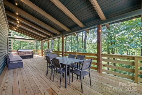 a view of a patio with table and chairs and wooden floor