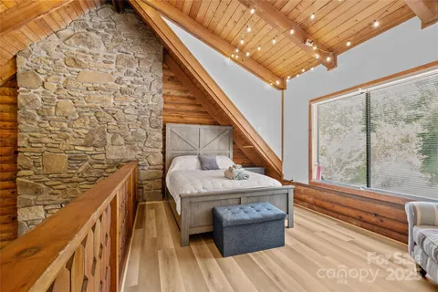 a balcony with couch and wooden floor