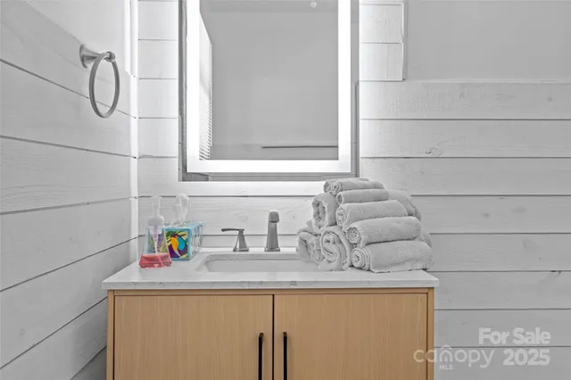 a bathroom with a sink and vanity