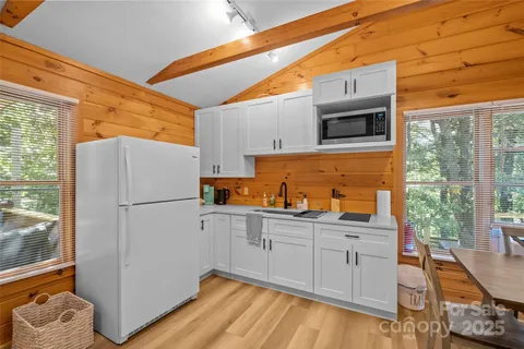 a kitchen with a refrigerator and a stove