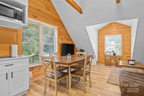 a view of a dining room with furniture wooden floor and a flat screen tv