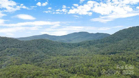 a view of a large mountain with mountains in the background