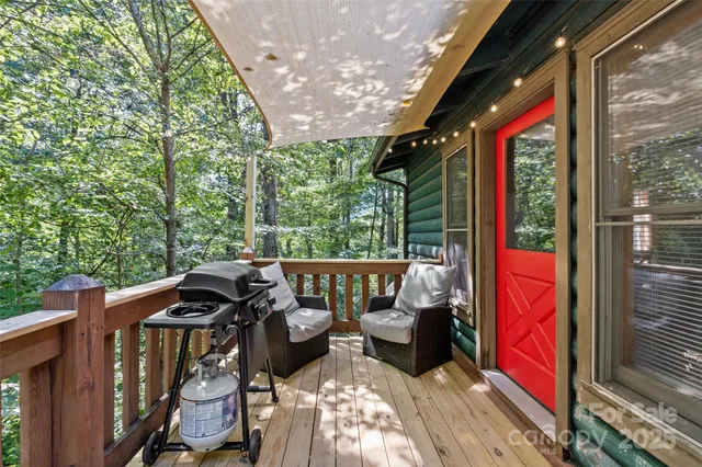 a view of balcony with chairs and wooden fence