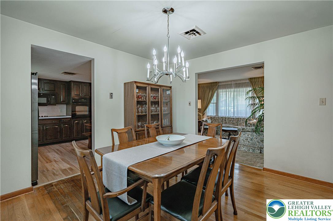 3045 Rambeau Road Bethlehem, PA 18020 - Photo 13 of 52 a view of a dining room with furniture and wooden floor