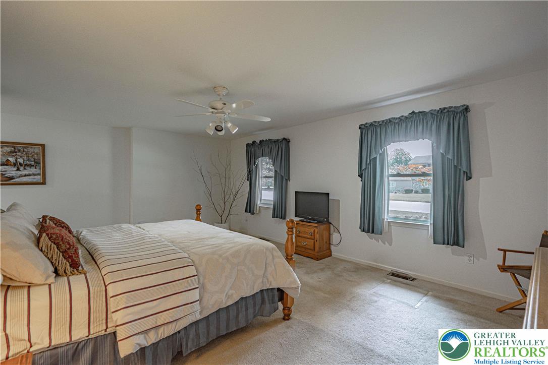 3045 Rambeau Road Bethlehem, PA 18020 - Photo 18 of 52 a bedroom with a large bed and a chandelier