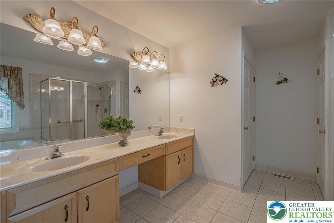 3045 Rambeau Road Bethlehem, PA 18020 - Photo 20 of 52 a bathroom with a sink a large mirror and a shower