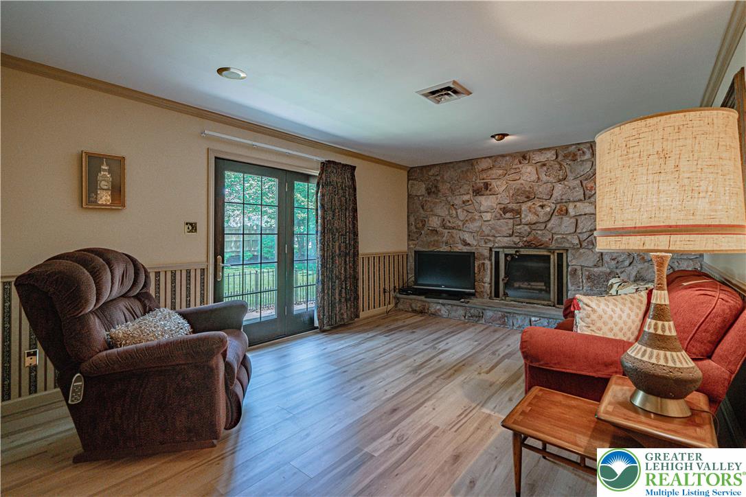 3045 Rambeau Road Bethlehem, PA 18020 - Photo 28 of 52 a living room with furniture a fireplace and a flat screen tv