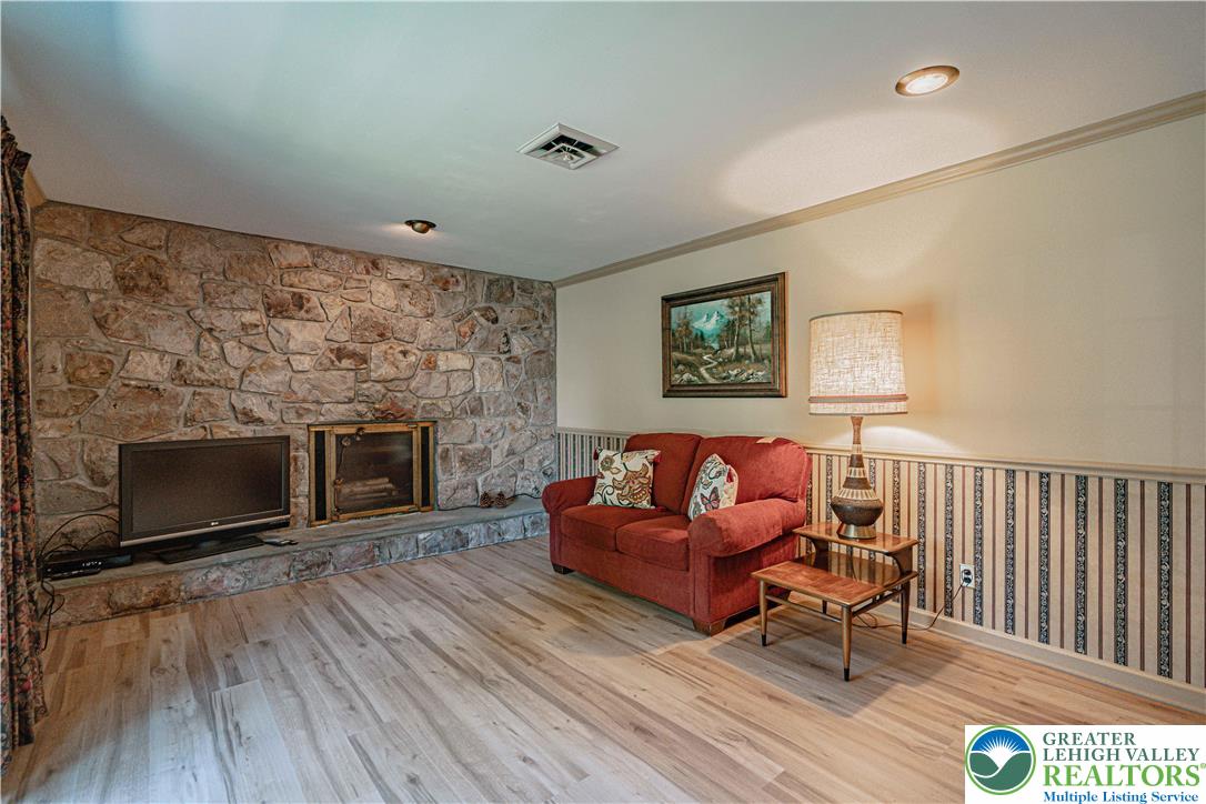3045 Rambeau Road Bethlehem, PA 18020 - Photo 29 of 52 a living room with furniture a flat screen tv and a fireplace