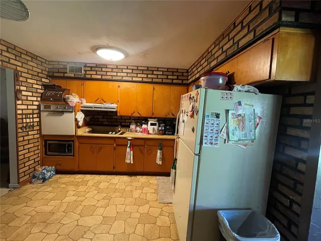 a kitchen with stainless steel appliances a refrigerator and stove