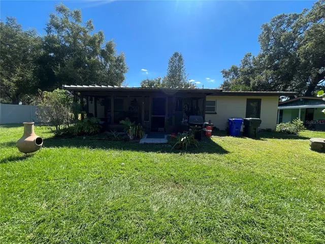 a view of a backyard with sitting area and furniture
