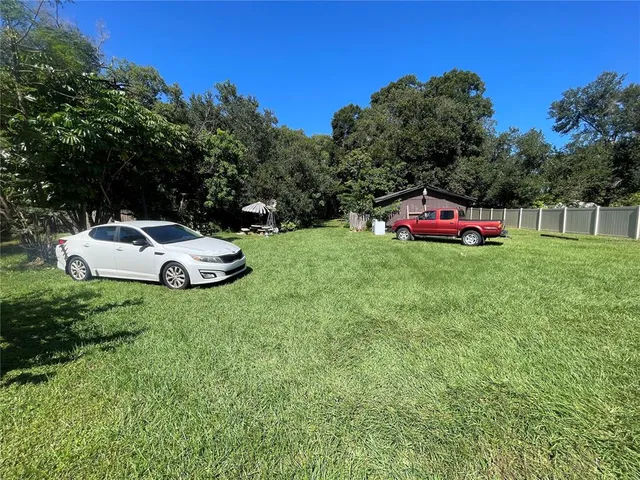 a backyard of a house with table and chairs