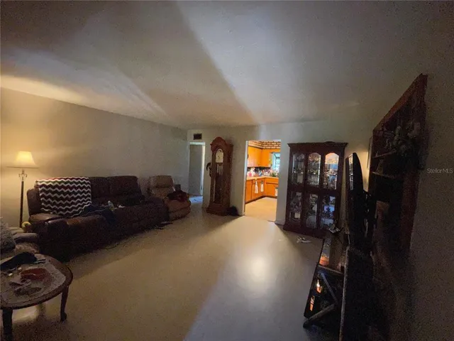 a living room with furniture a ceiling fan and a window