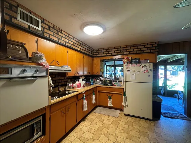 a kitchen with a refrigerator and a stove
