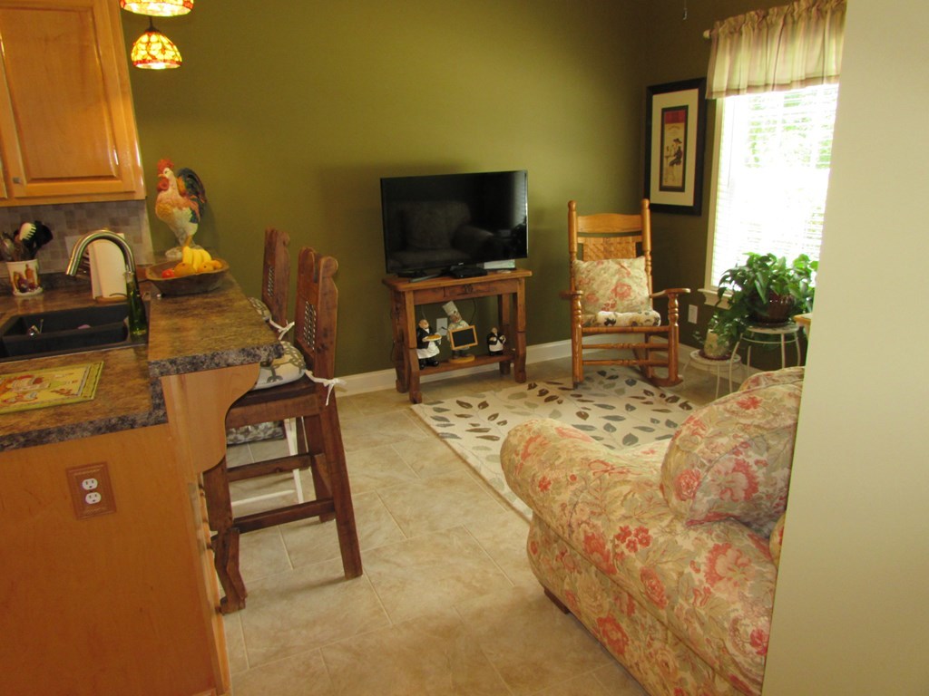 7440 Goodall Mill Road Macon, GA 31216 - Photo 13 of 33 a living room with chair and a flat screen tv