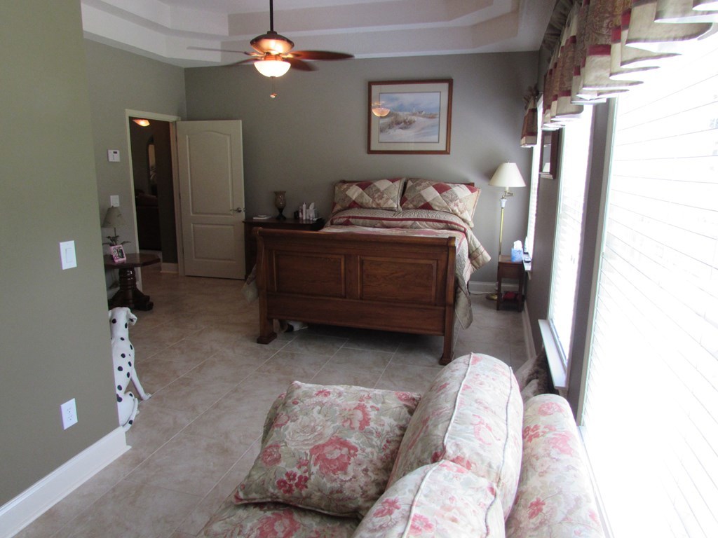 7440 Goodall Mill Road Macon, GA 31216 - Photo 16 of 33 a bedroom with bed and a chandelier