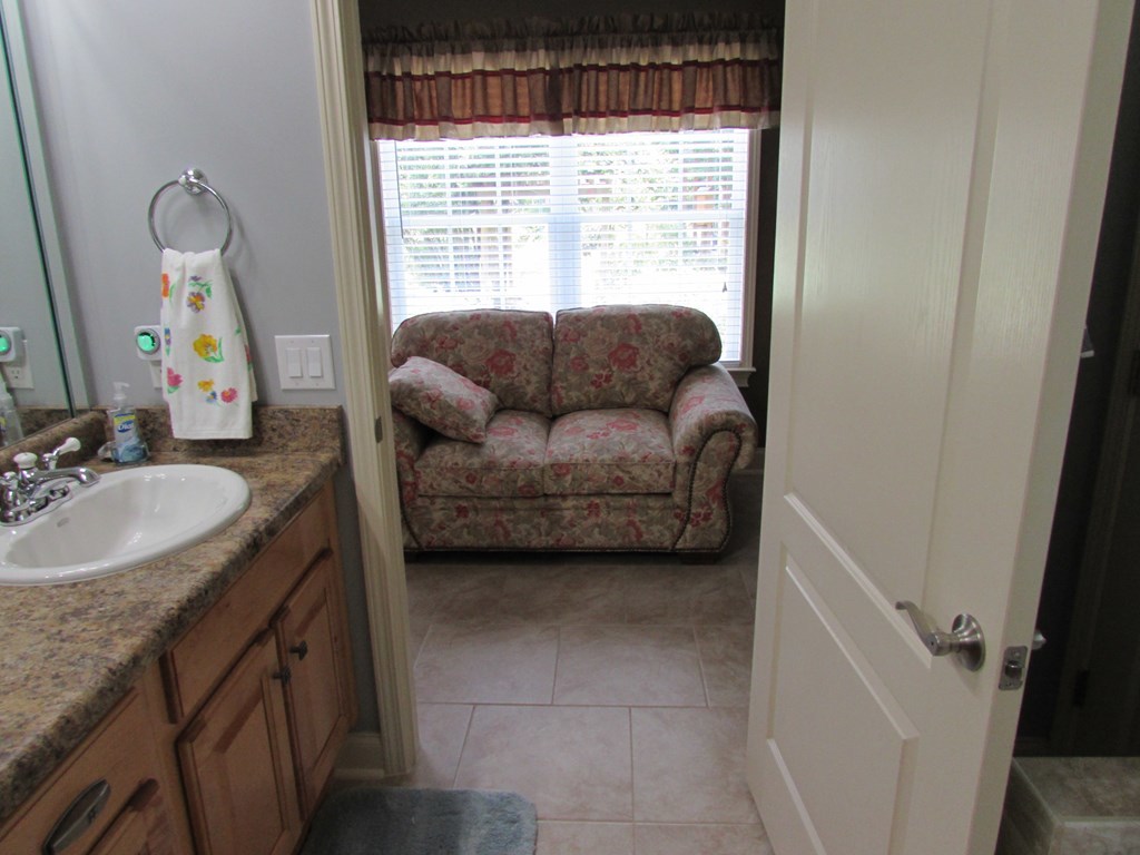 7440 Goodall Mill Road Macon, GA 31216 - Photo 18 of 33 a en suite bathroom with a granite countertop sink and a mirror