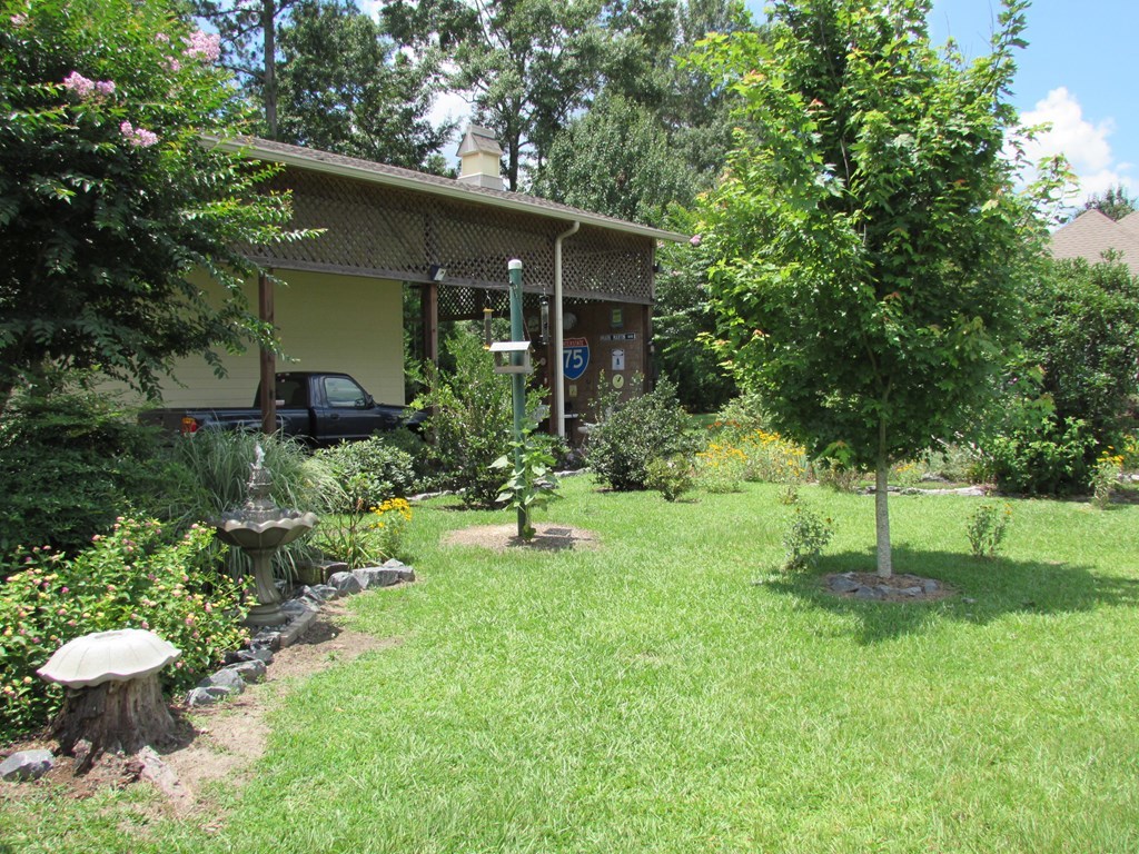 7440 Goodall Mill Road Macon, GA 31216 - Photo 30 of 33 a view of backyard of house with green space and fountain