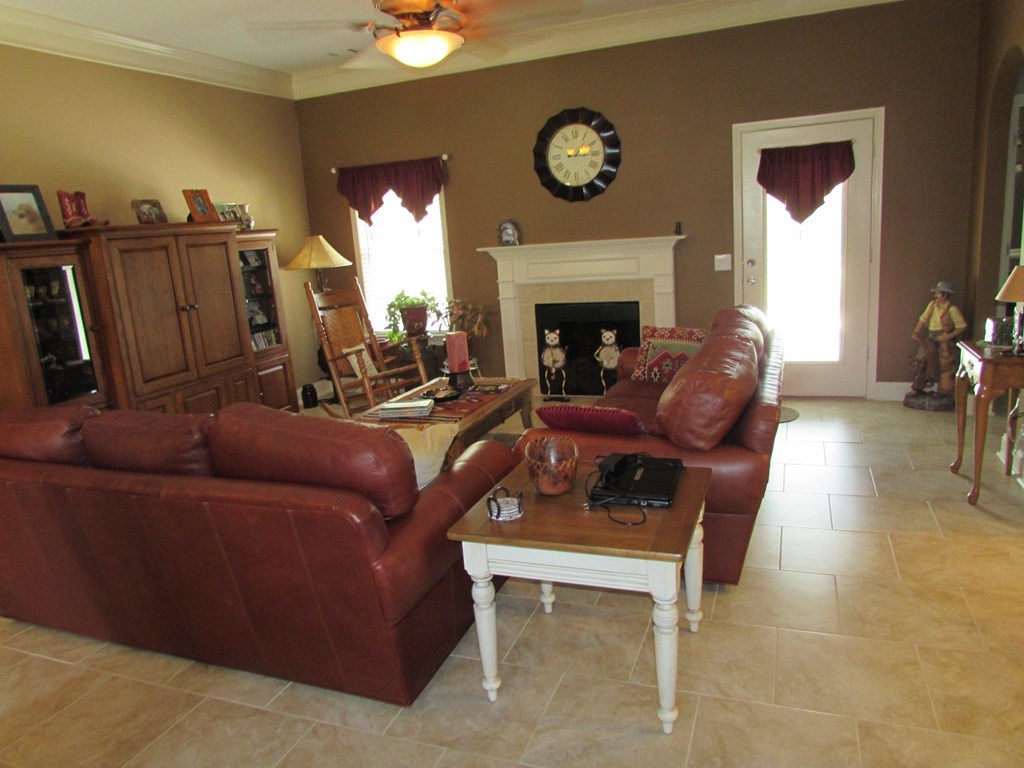7440 Goodall Mill Road Macon, GA 31216 - Photo 7 of 33 a living room with furniture and a fireplace