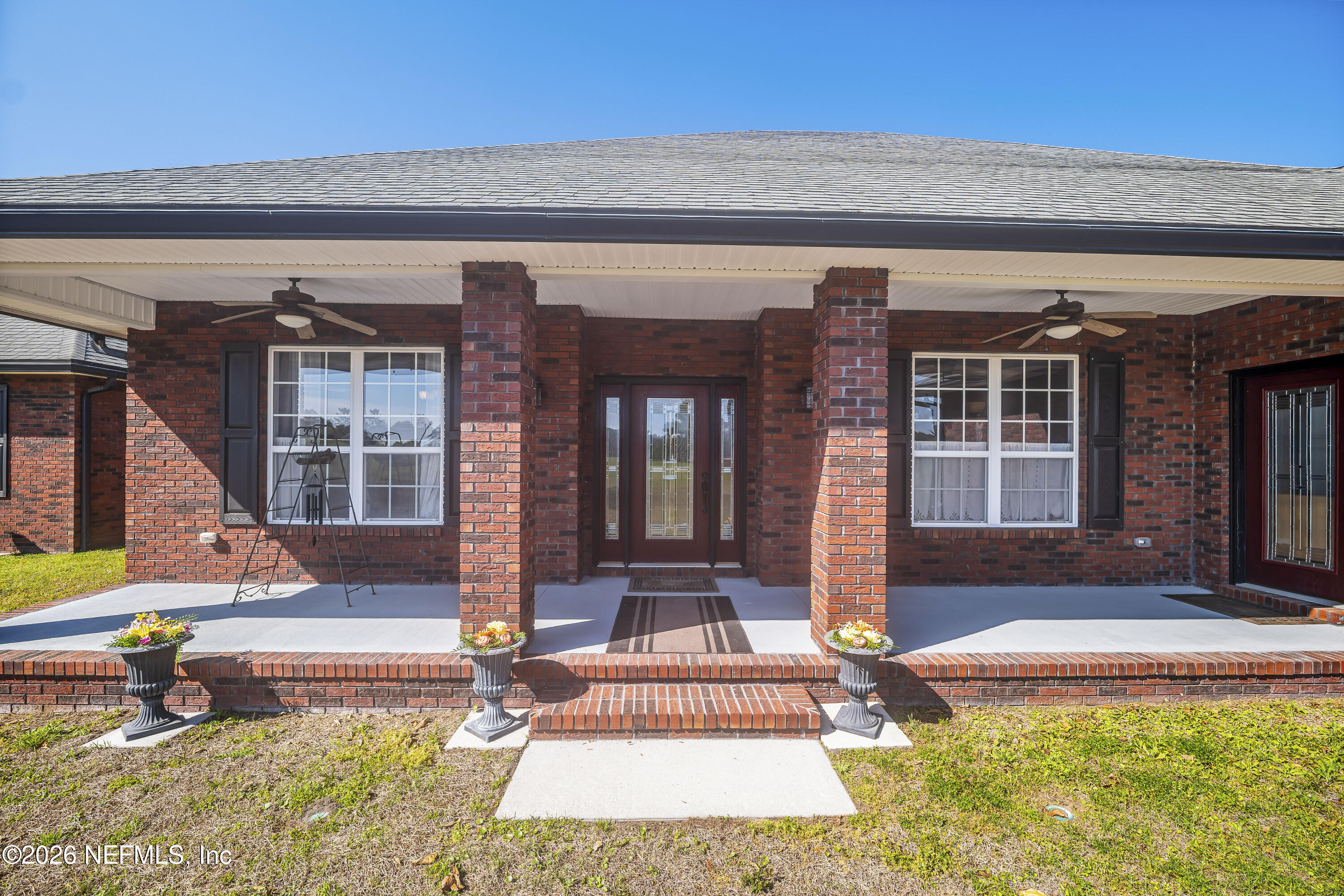 371154 Kings Ferry Road Hilliard, FL 32046 - Photo 11 of 65 front view of house with a swimming pool