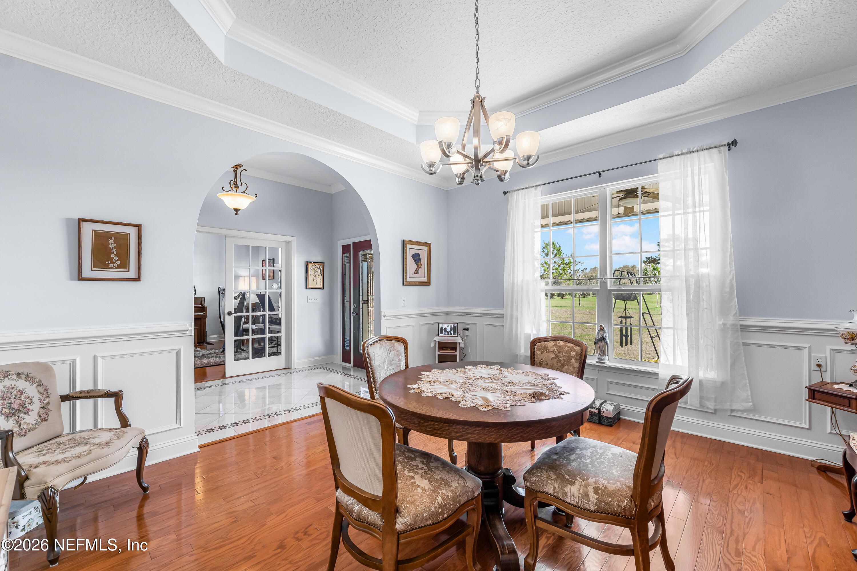 371154 Kings Ferry Road Hilliard, FL 32046 - Photo 16 of 65 a view of a dining room with furniture window and wooden floor