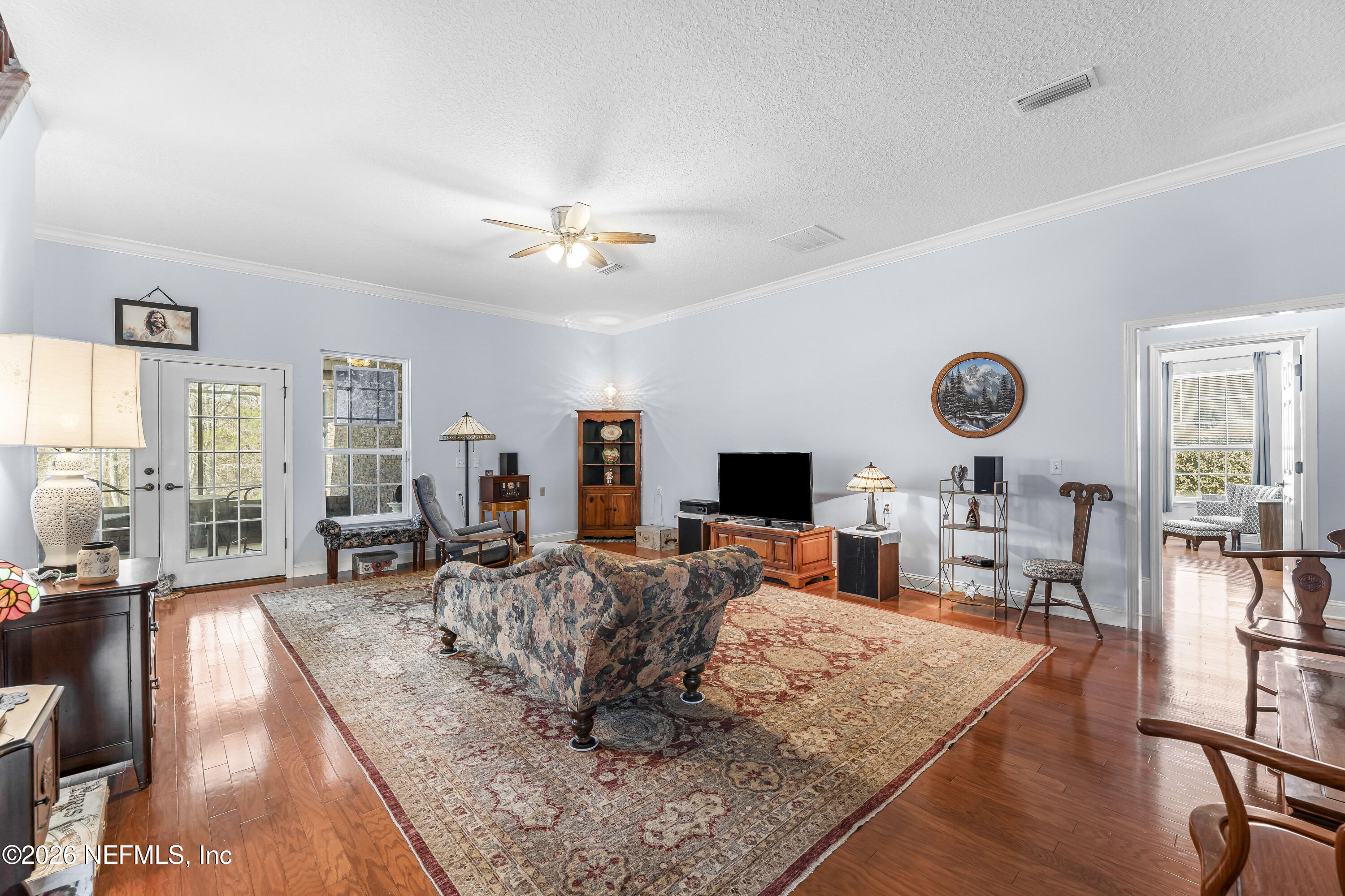 371154 Kings Ferry Road Hilliard, FL 32046 - Photo 18 of 65 a living room with furniture flat screen tv and large window