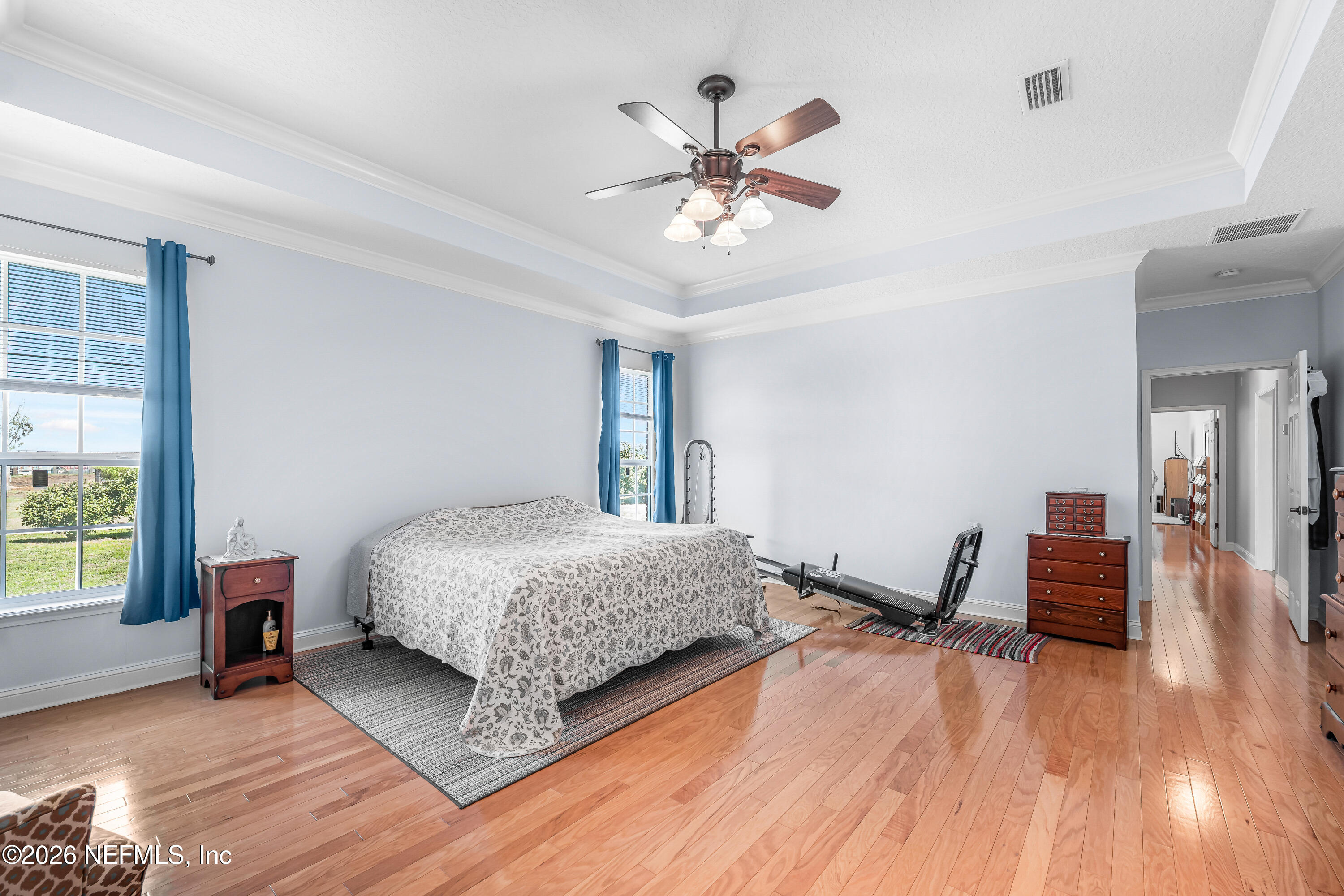 371154 Kings Ferry Road Hilliard, FL 32046 - Photo 27 of 65 a bedroom with a bed and a chandelier