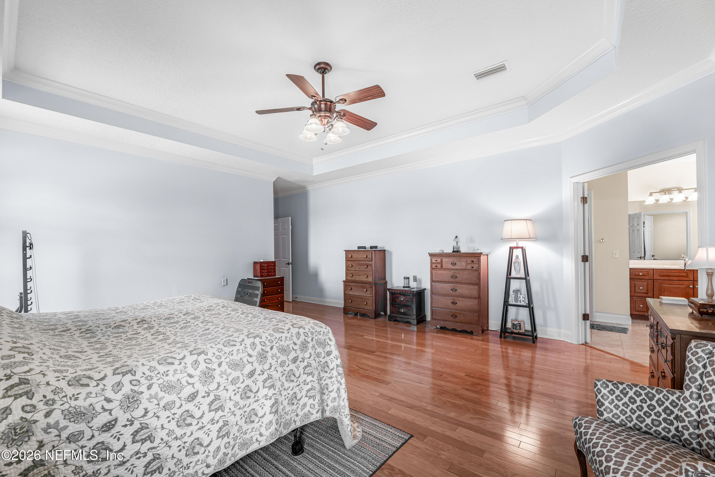 371154 Kings Ferry Road Hilliard, FL 32046 - Photo 28 of 65 a bedroom with furniture and a chandelier