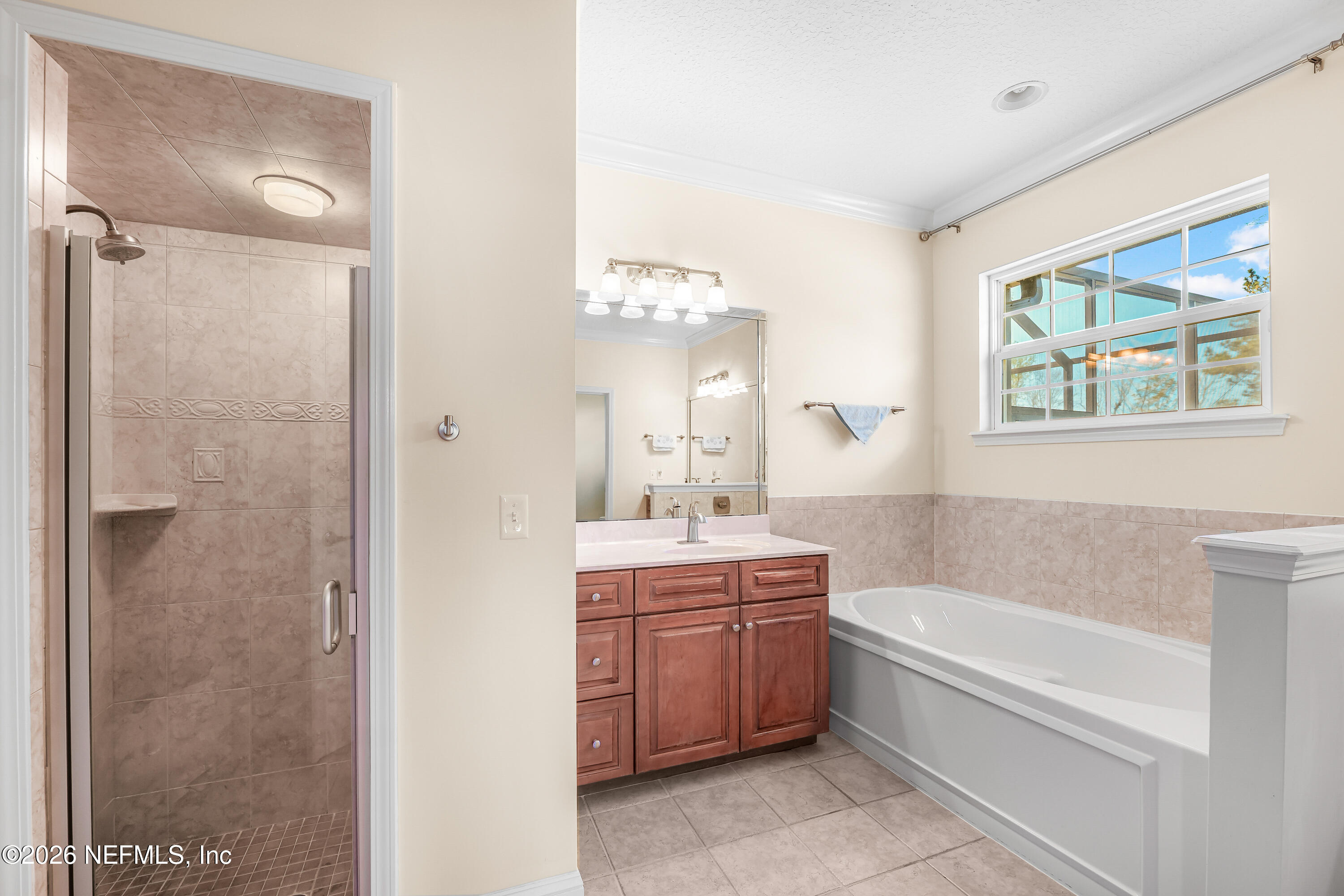 371154 Kings Ferry Road Hilliard, FL 32046 - Photo 29 of 65 a bathroom with a tub sink and mirror