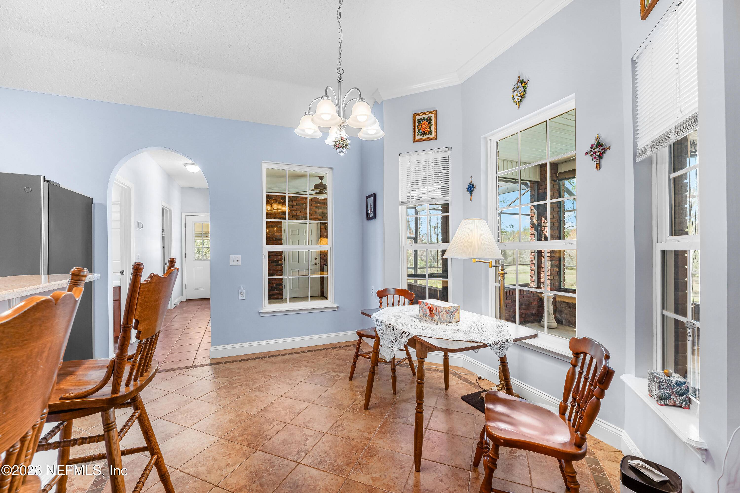 371154 Kings Ferry Road Hilliard, FL 32046 - Photo 32 of 65 a view of a dining room with furniture and a chandelier