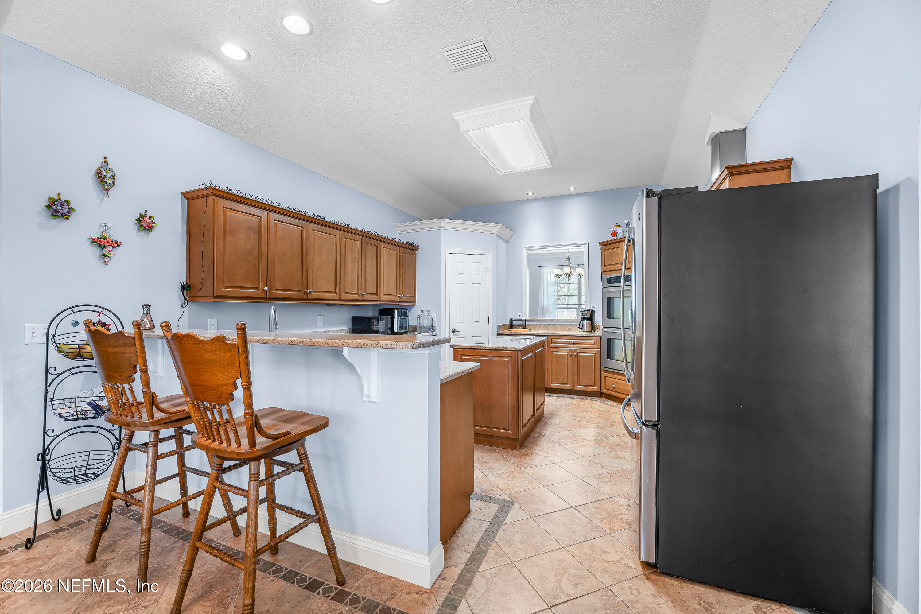 371154 Kings Ferry Road Hilliard, FL 32046 - Photo 33 of 65 a kitchen with stainless steel appliances granite countertop a refrigerator and a stove top oven