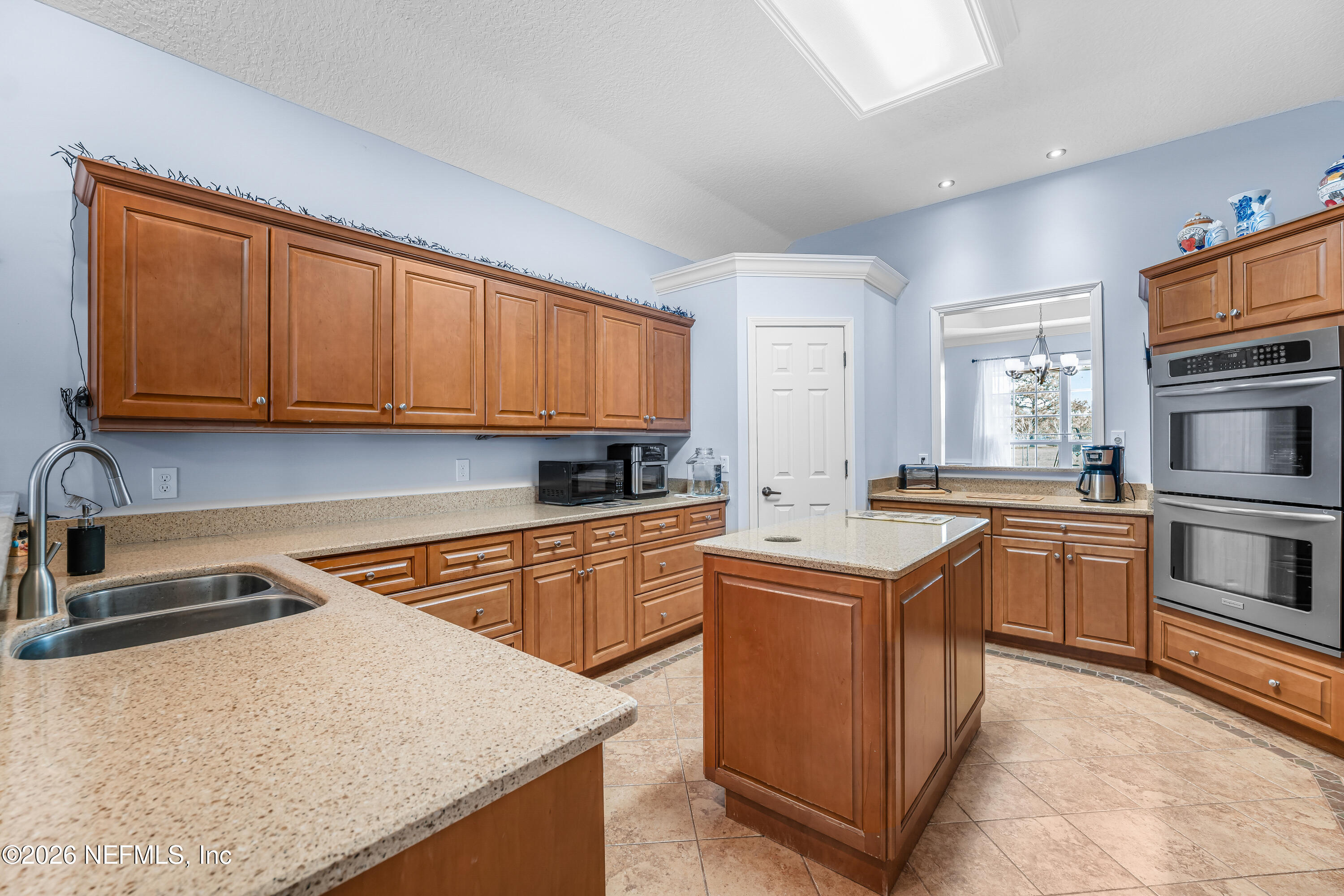 371154 Kings Ferry Road Hilliard, FL 32046 - Photo 34 of 65 a kitchen with stainless steel appliances granite countertop a stove top oven sink and cabinets