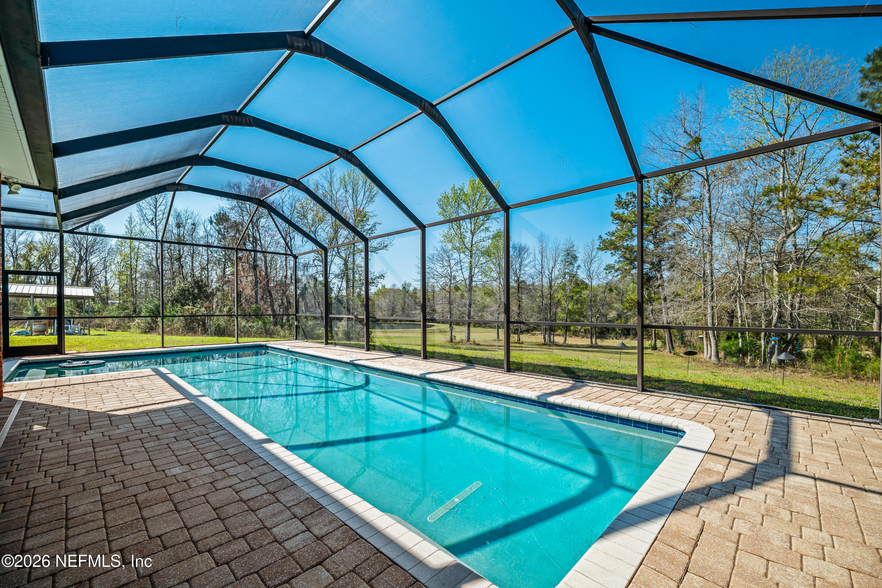371154 Kings Ferry Road Hilliard, FL 32046 - Photo 47 of 65 a view of a backyard with swimming pool