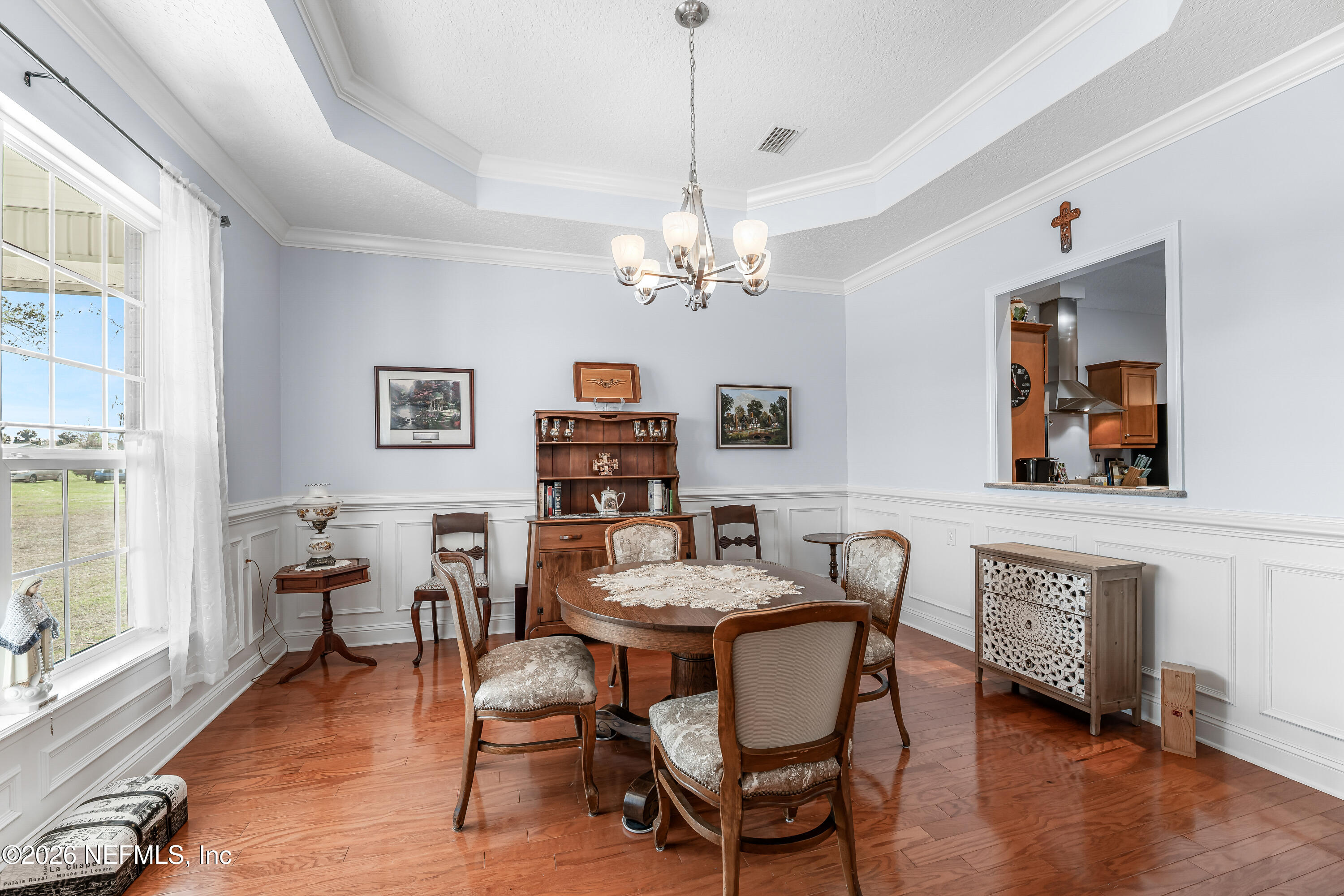 371154 Kings Ferry Road Hilliard, FL 32046 - Photo 6 of 65 a dining room with furniture a chandelier and wooden floor