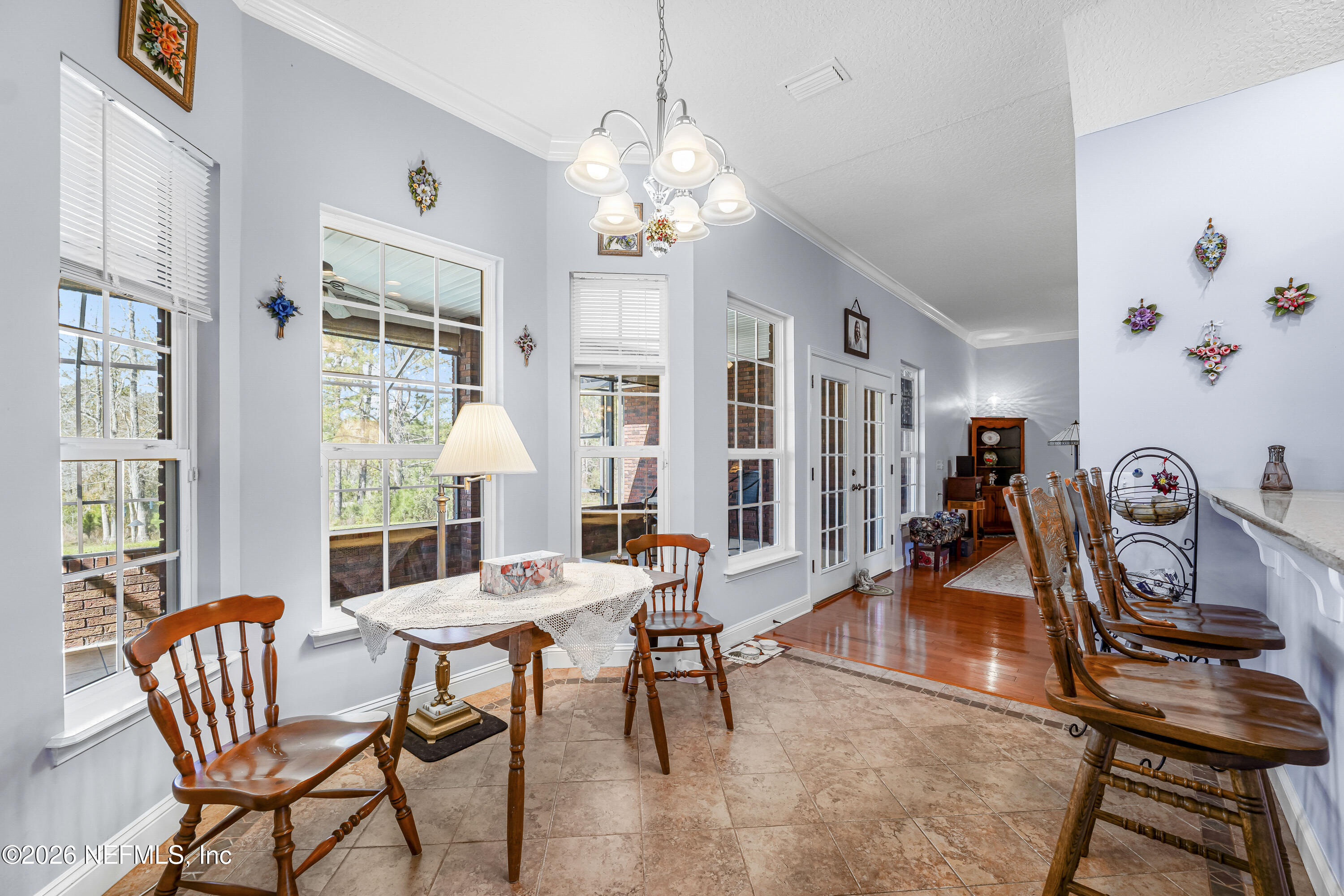 371154 Kings Ferry Road Hilliard, FL 32046 - Photo 7 of 65 a dining room with furniture a chandelier and wooden floor