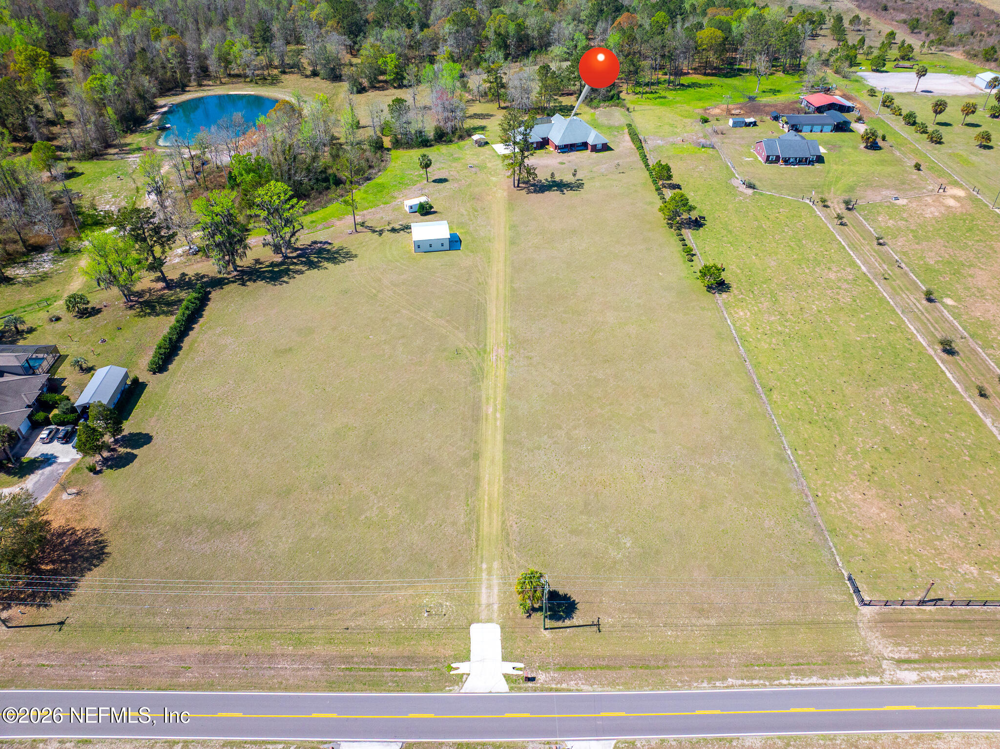 371154 Kings Ferry Road Hilliard, FL 32046 - Photo 10 of 65 a view of a swimming pool with an outdoor space and seating area