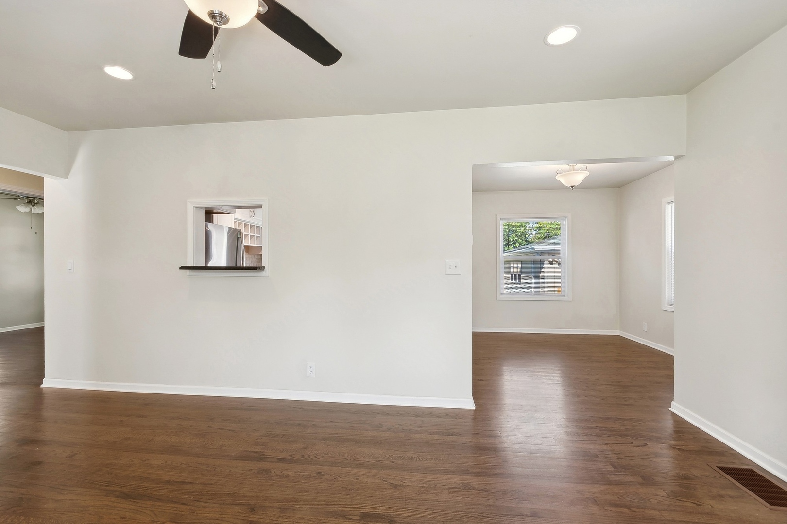 1513 Marquette Road Joliet, IL 60435 - Photo 4 of 16 an empty room with wooden floor and windows