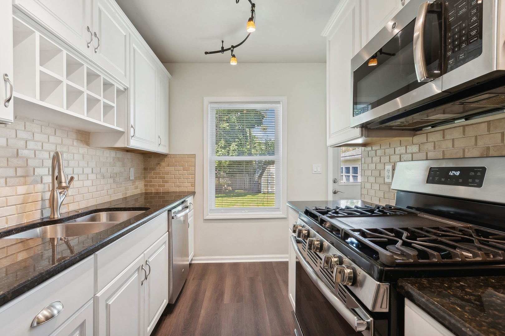 1513 Marquette Road Joliet, IL 60435 - Photo 6 of 16 a kitchen with stainless steel appliances granite countertop a stove and a sink