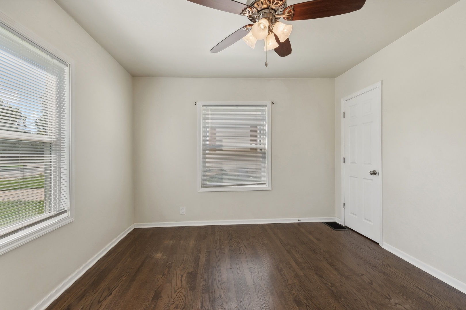 1513 Marquette Road Joliet, IL 60435 - Photo 7 of 16 a view of an empty room with wooden floor and a window